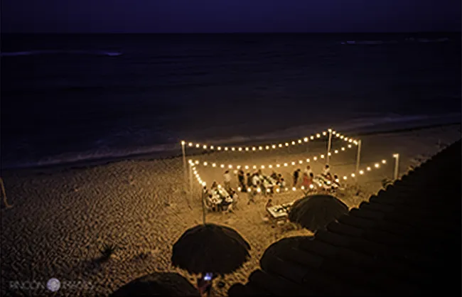 wedding reception held on the beach at night